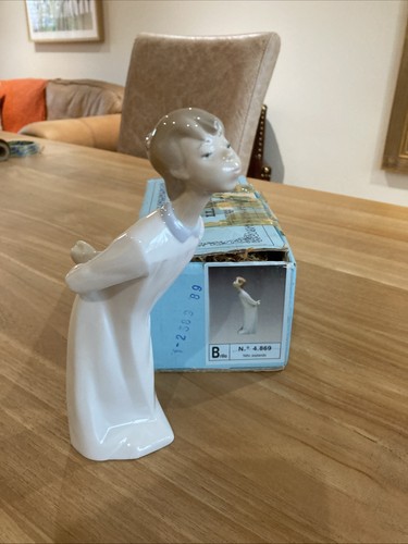 Lladro 4869 boy blowing a - “boy,